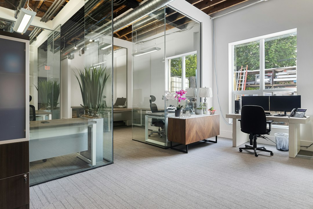 a room with a desk and chairs