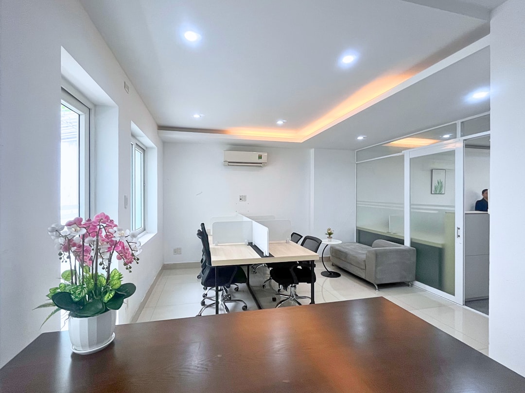 Modern office space with desks, chairs, and sofa