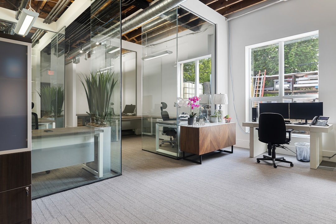 a room with a desk and chairs